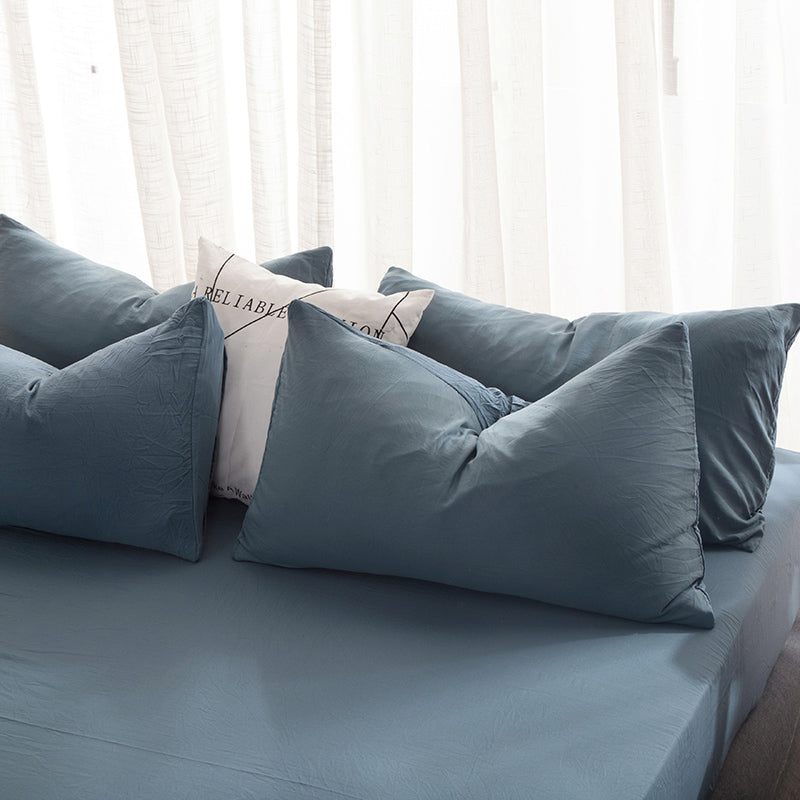 Washed cotton pillowcases on a bed