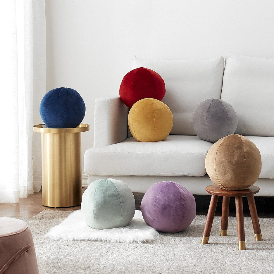 Velvet ball throw pillows styled in a living room