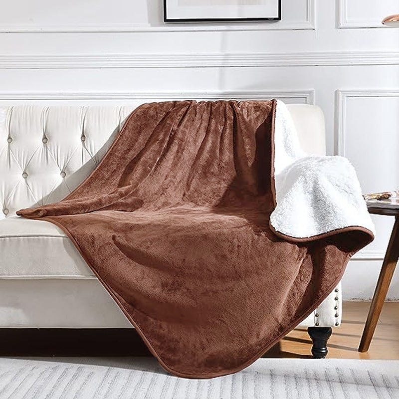 Grey sherpa blanket on a bed