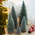Frosted green bottle brush mini Christmas trees on wood slice bases – view 1