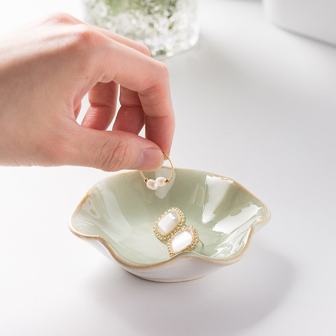 Lotus leaf ceramic trinket dish holding earrings – view 2
